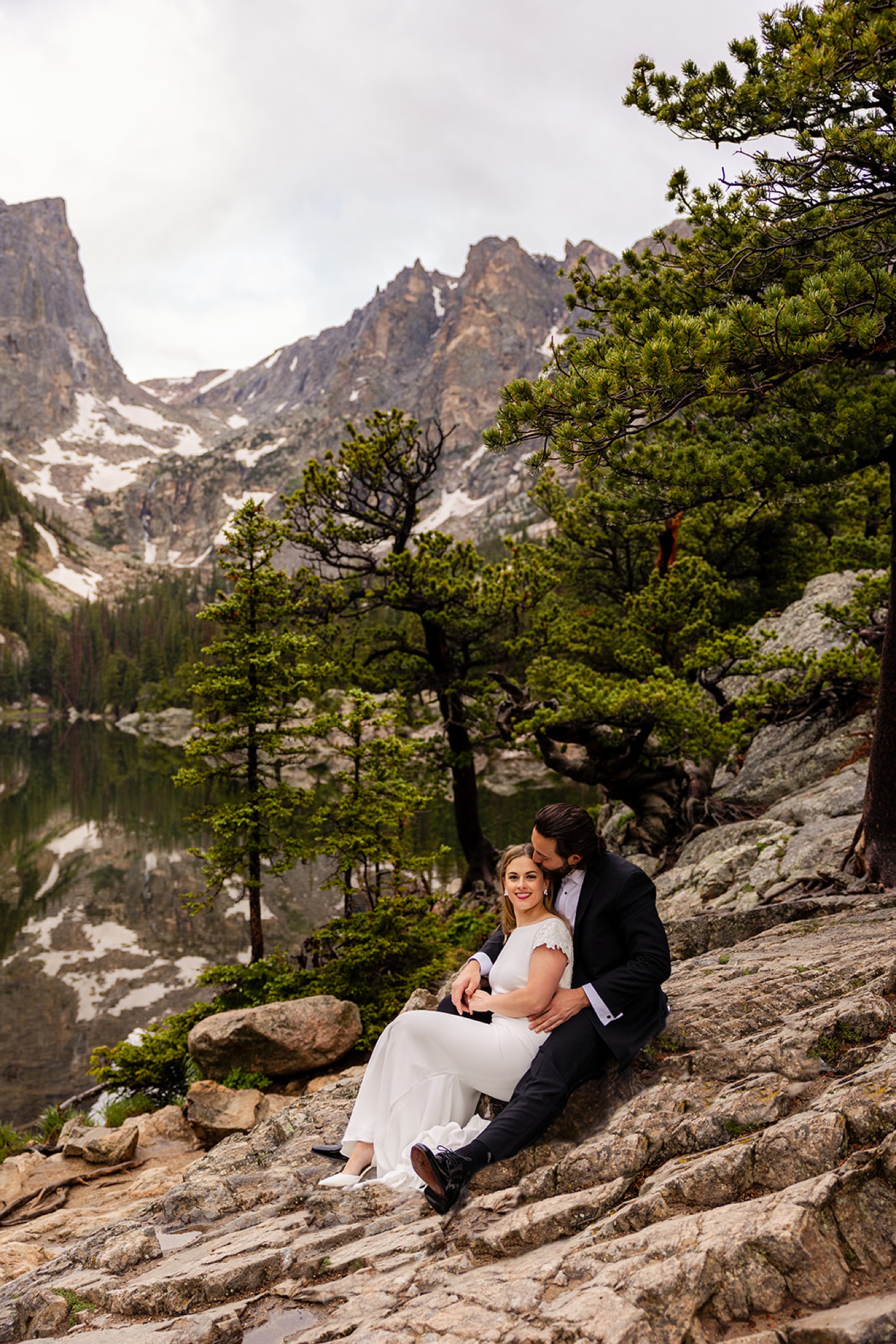 Bride and groom hike up a mountain for their wedding day portraits